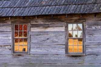 Autumn reflections in windows of an old cabin, Cumberland Gap Na